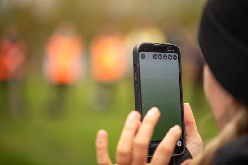 woman using iphone to take an image of nature and tree plating activities