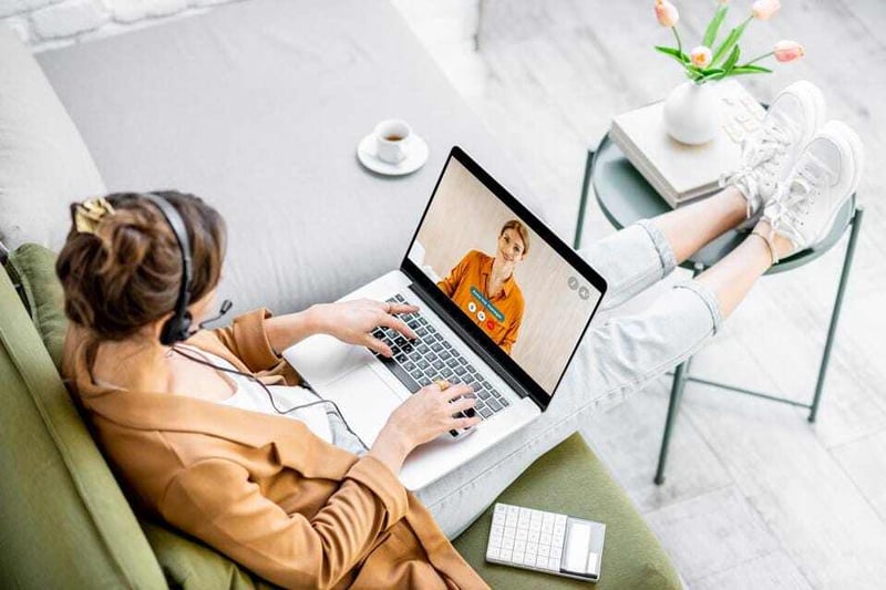 young girl working from home with laptop
